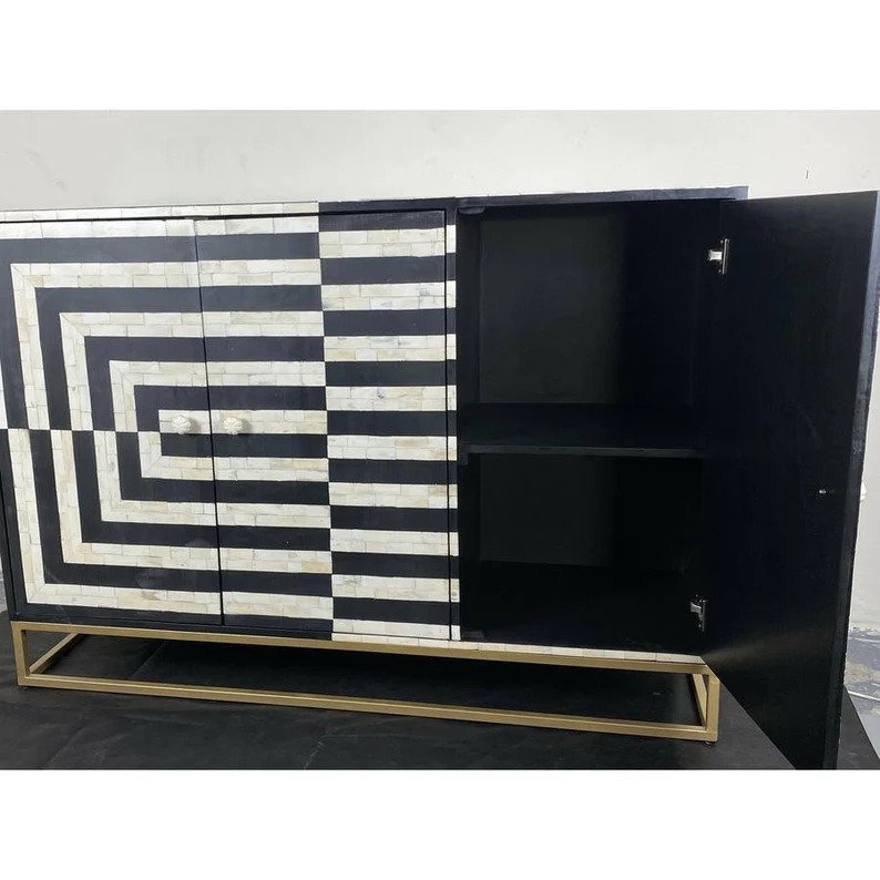 Black and white bone inlay credenza with one door open revealing interior shelf compartment, optical illusion inlay pattern visible on cabinet doors and sides