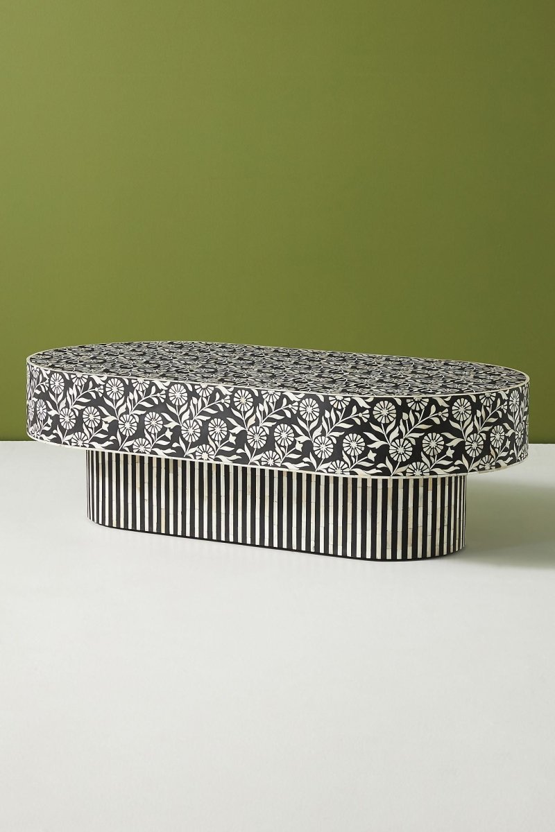 Black White Inlay Cocktail Table in black and white, shown from the side with its oval silhouette and striped floral surface.