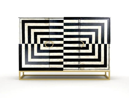 Black and white geometric optical illusion bone inlay buffet cabinet on gold sled base with ring pulls, photographed against clean white background