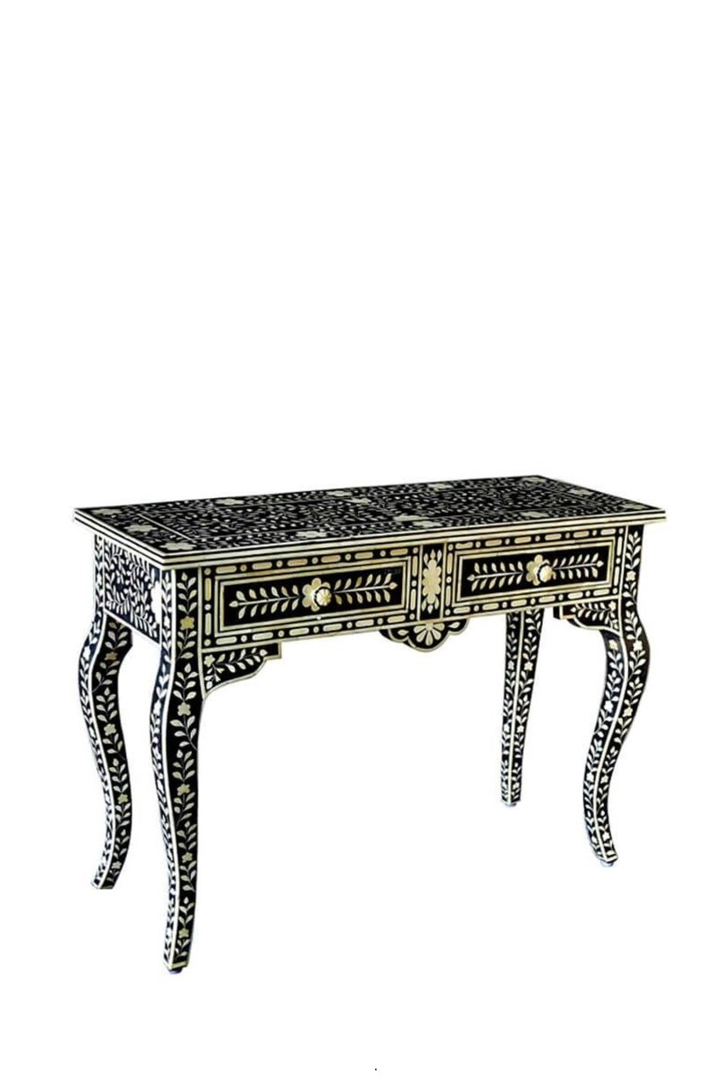 Front angle view of a black and white bone inlay entryway table with two drawers, showing the hand-carved floral vine pattern, scalloped apron, curved cabriole legs, and black-and-white inlay across the tabletop and front on a white background.