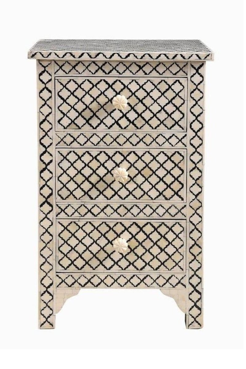 Black and white bone inlay nightstand with geometric lattice pattern, three drawers, and carved flower knobs on solid wood, handmade in India