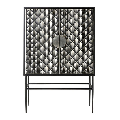 Bone inlay 2-door bar cabinet with full-coverage black and white spike chevron pattern across both doors, a circular center door pull, and a black powder-coated iron stand with tapered pointed legs on white background