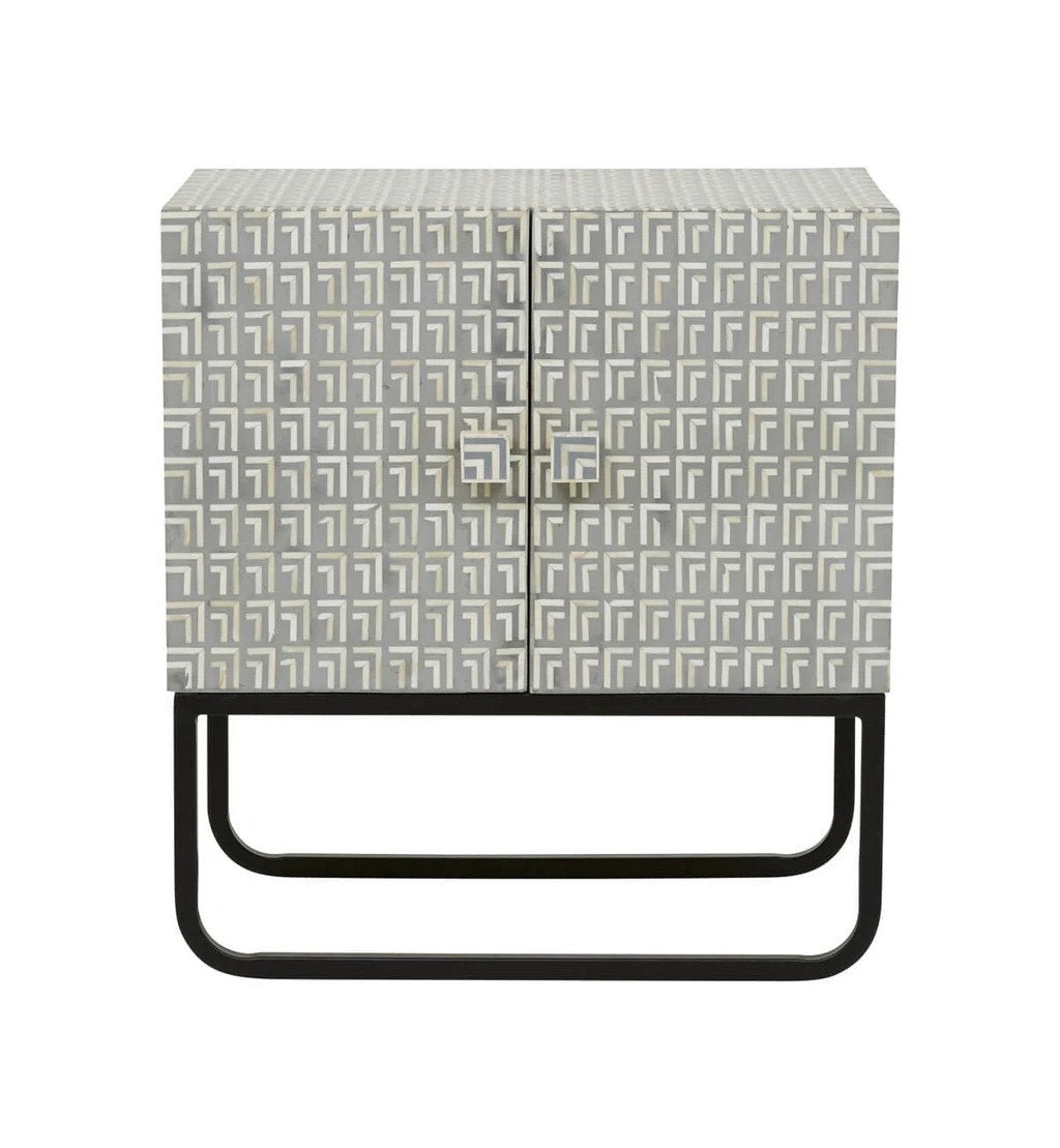 Art Deco grey bone inlay two-door cabinet nightstand with geometric L-pattern inlay and black iron sled base, isolated white background