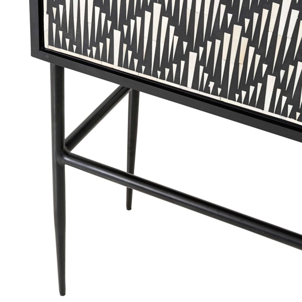 Lower section of a bone inlay bar cabinet showing the black powder-coated iron stand with tapered pointed legs, rectangular cross-brace stretcher, and the bottom edge of the black and white inlay door panels above