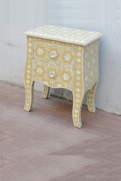 Bone Inlay Curved-Leg Commode in mustard yellow shown at a side angle with two drawers and geometric star detailing