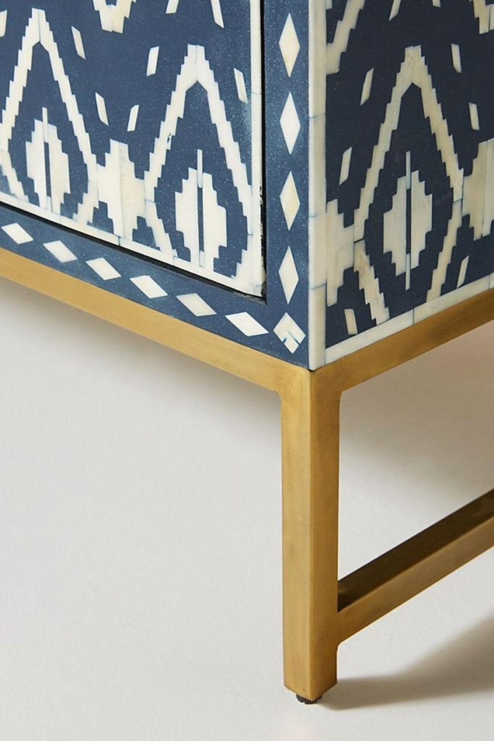 Indigo blue and ivory bone inlay accent cabinet with geometric Ikat pattern, drawer storage, two doors, and metal base.