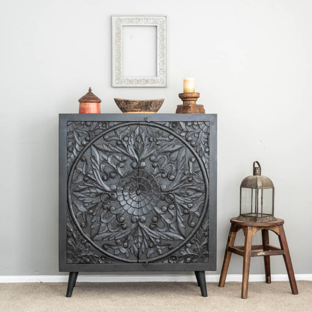 Charcoal Carved Wooden accent cabinet , shown in front view with leaf motifs and ring handles.