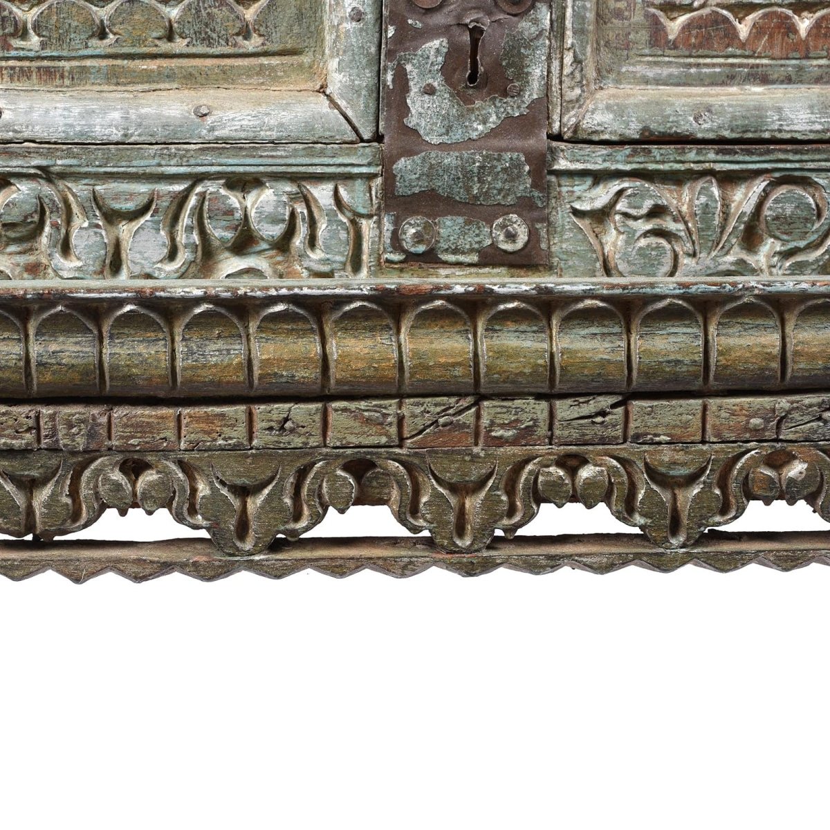 Decorative wood storage cabinet, base detail view of scalloped carving, rounded trim and a weathered metal keyhole plate.