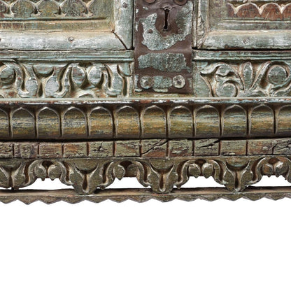 Decorative wood storage cabinet, base detail view of scalloped carving, rounded trim and a weathered metal keyhole plate.