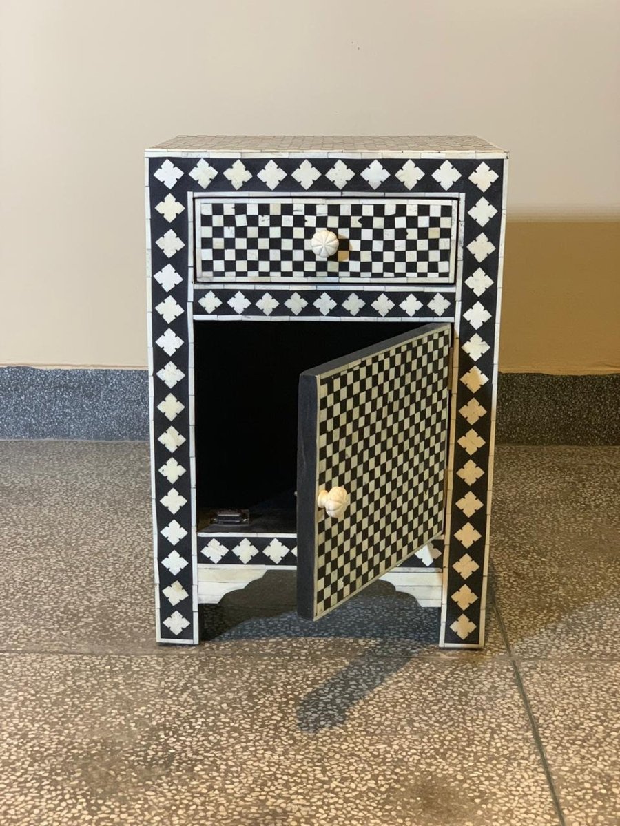 Designer black and white bone inlay side table with checkerboard drawer panel, diamond border detailing, lower cabinet with carved bone knob pull, solid arched wooden base