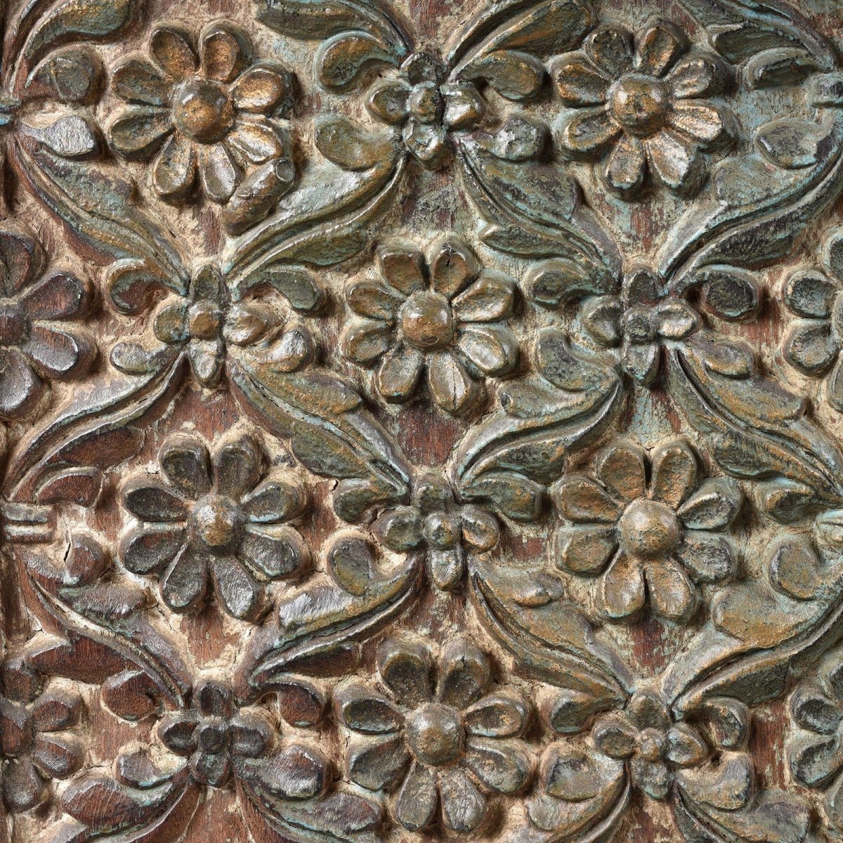 Floral relief wood server with muted green patina, close-up of carved surface detail showing raised flowers and vines.