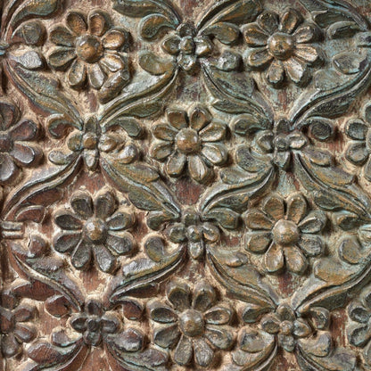 Floral relief wood server with muted green patina, close-up of carved surface detail showing raised flowers and vines.