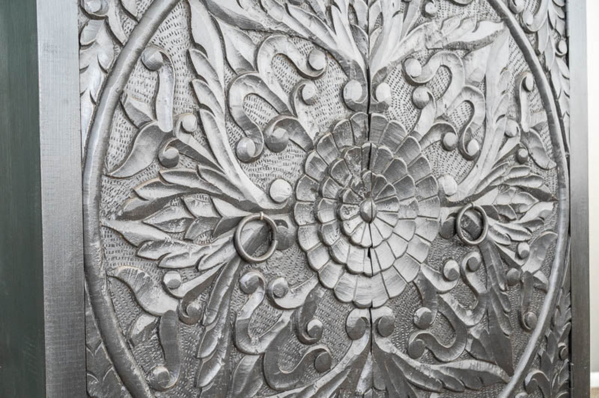 Floral Ring Pull Cabinet in charcoal wood, shown in front view close-up with a central rosette and raised leaf carvings.