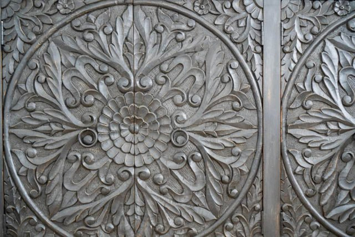 Floral Ring Pull Sideboard in black wood, shown in front view cropped to reveal circular borders and leaf carvings.