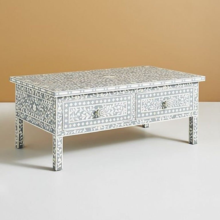 Slate grey and white bone inlay coffee table shown in a straight front view, displaying the floral vine pattern, geometric border, two drawer fronts, and matching round knobs on the rectangular handmade center table.