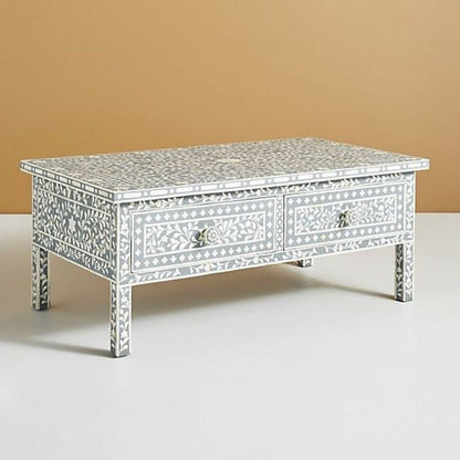 Slate grey and white bone inlay coffee table shown in a straight front view, displaying the floral vine pattern, geometric border, two drawer fronts, and matching round knobs on the rectangular handmade center table.