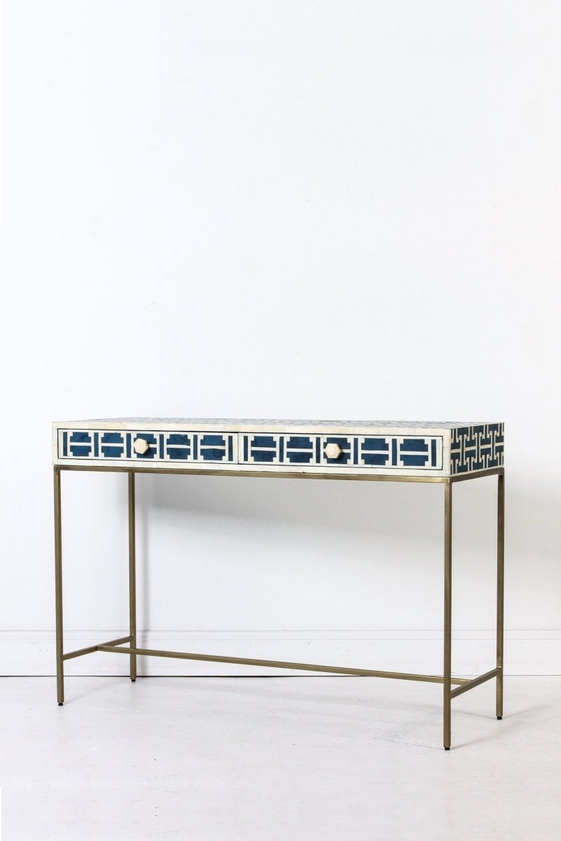 Left front angle of the dark blue bone inlay sofa table, showing the geometric lattice pattern over the rectangular top and two drawer fronts. The angled view shows the slim table depth, drawer layout, and gold-toned legs for a hallway, entryway, or office.