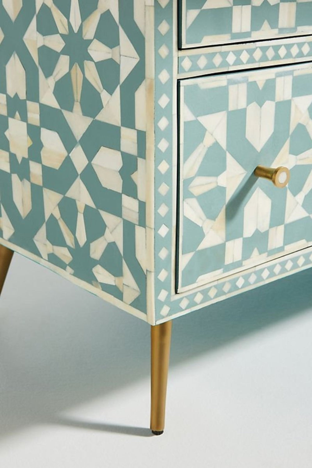 Moroccan bone inlay chiffonier is presented in a close-up furniture view, showing its leg