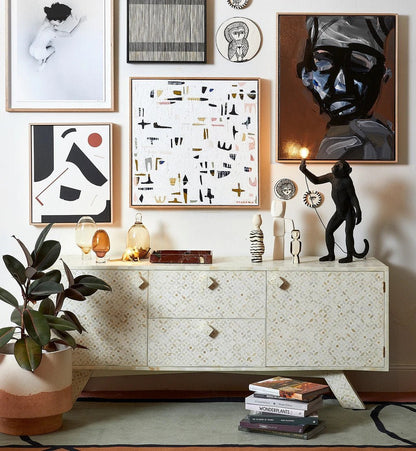 Ivory bone inlay sideboard with star geometric pattern, 2 doors and 2 drawers, styled in an eclectic gallery wall living room with sculptural decor and tropical plants