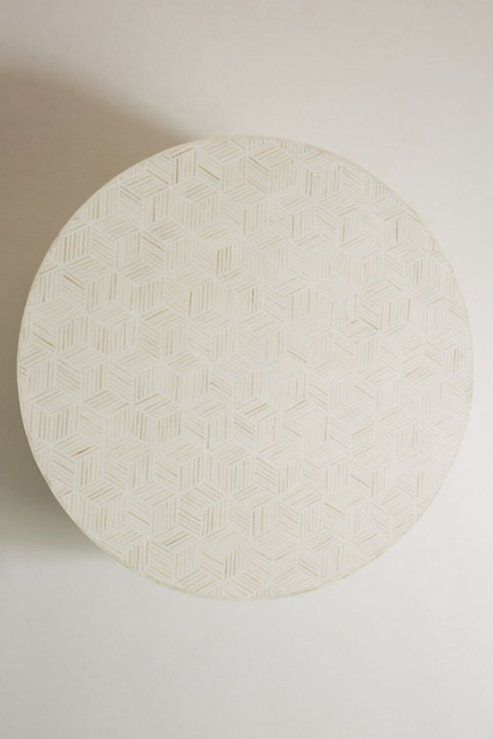 Geometric White Accent Table with bone inlay, captured from a top-down view showing the round patterned tabletop.