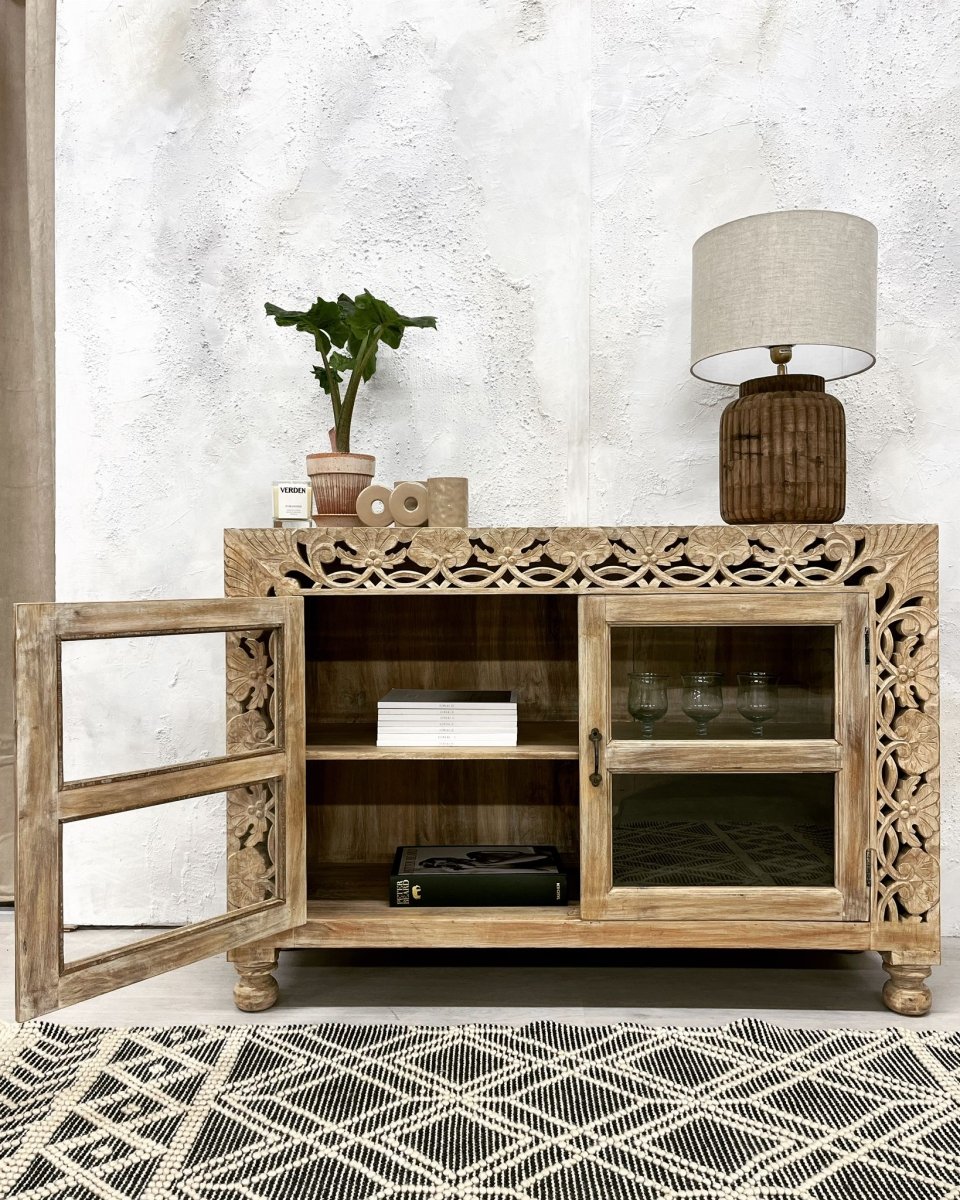Glass door wooden buffet in a rustic finish, front view with the left door open, showing shelves and stacked books.