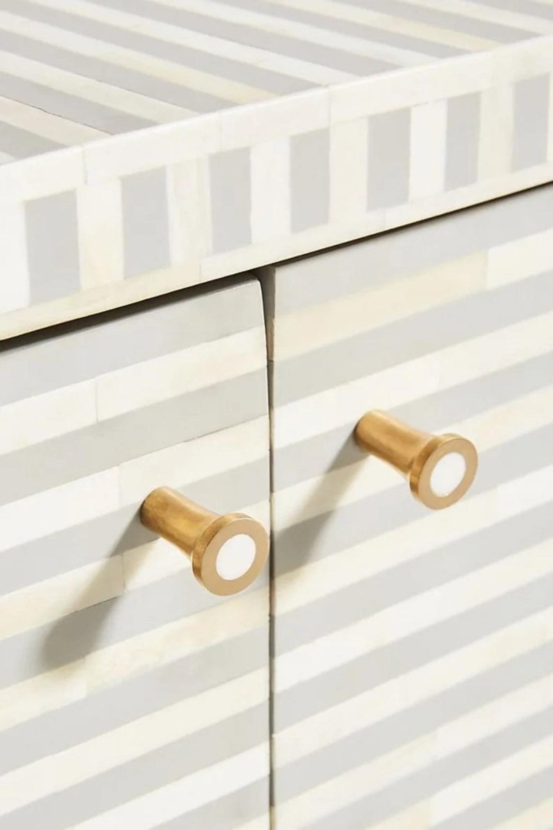 Front view of a handmade grey bone inlay buffet sideboard with visible cabinet handles, showing the curved furniture form and horizontal bone inlay stripe pattern across the front. The image presents the complete indoor storage cabinet with its functional handle details.