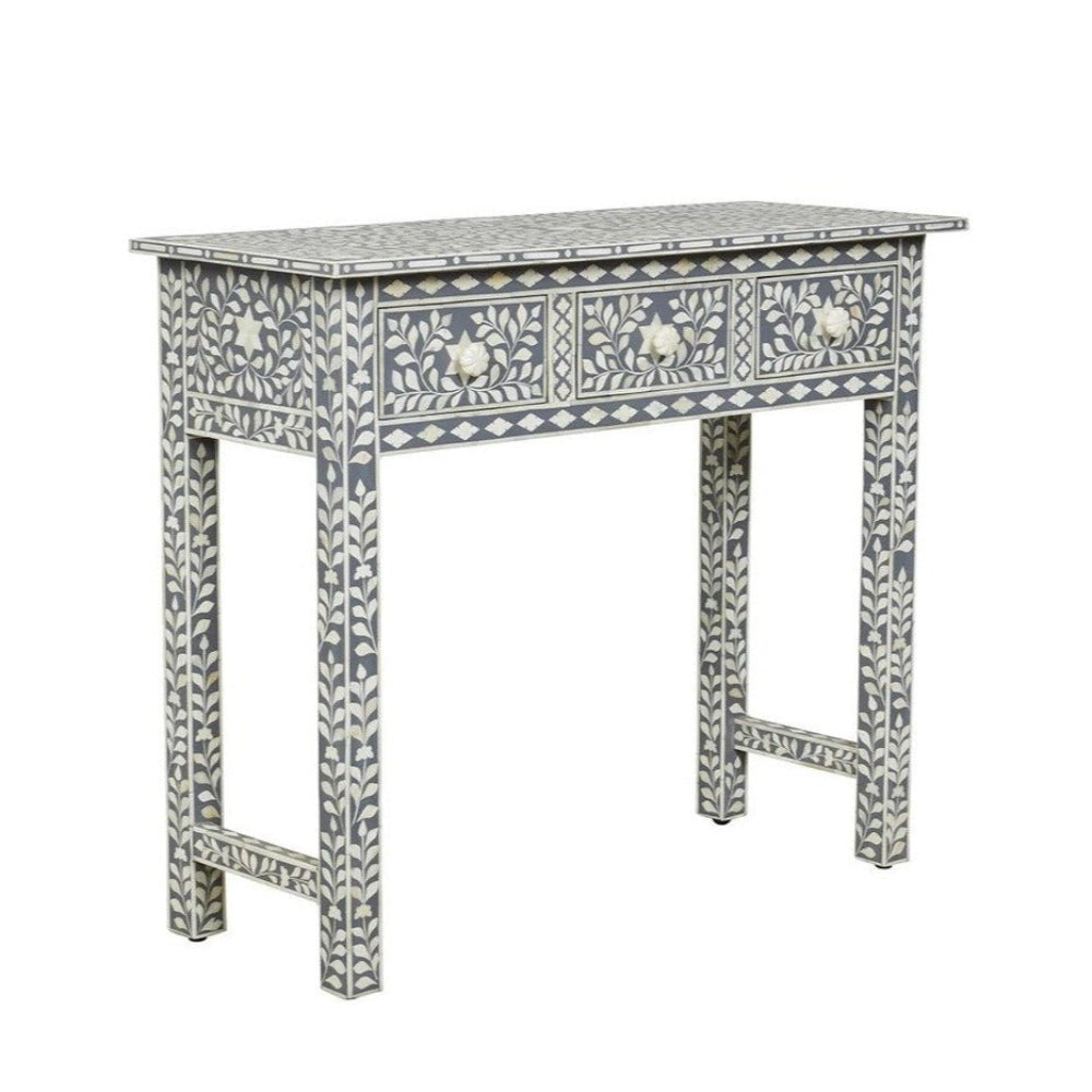 Grey and white bone inlay three drawer console table with floral vine inlay on drawers, legs, and tabletop, with flower-shaped bone drawer pulls on white background