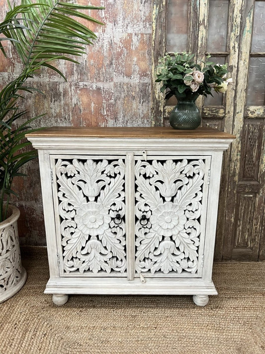 Hand-carved floral accent cabinet in rustic wood, front view with two ornate doors, ring pulls and a wood top.