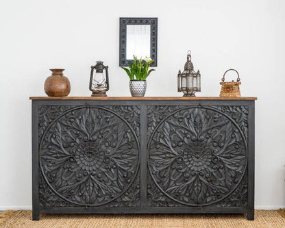 Hand Carved Large Buffet Table in black wood, shown in front view with floral mandala doors, lanterns and flowers.