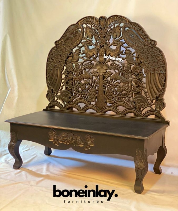 Hand carved woodland settee in rustic solid wood, front view showing an openwork peacock backrest and curved legs.