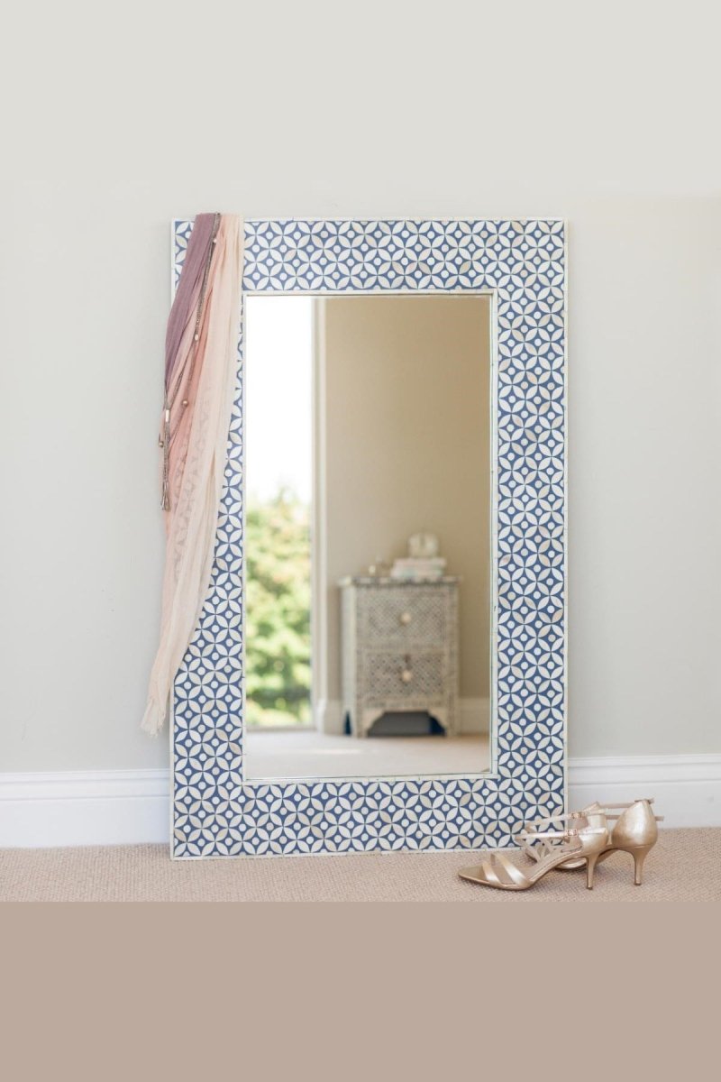 Blue bone inlay wall mirror frame displayed above a white fireplace mantel in a furnished room, showing its rectangular blue-and-ivory patterned frame.