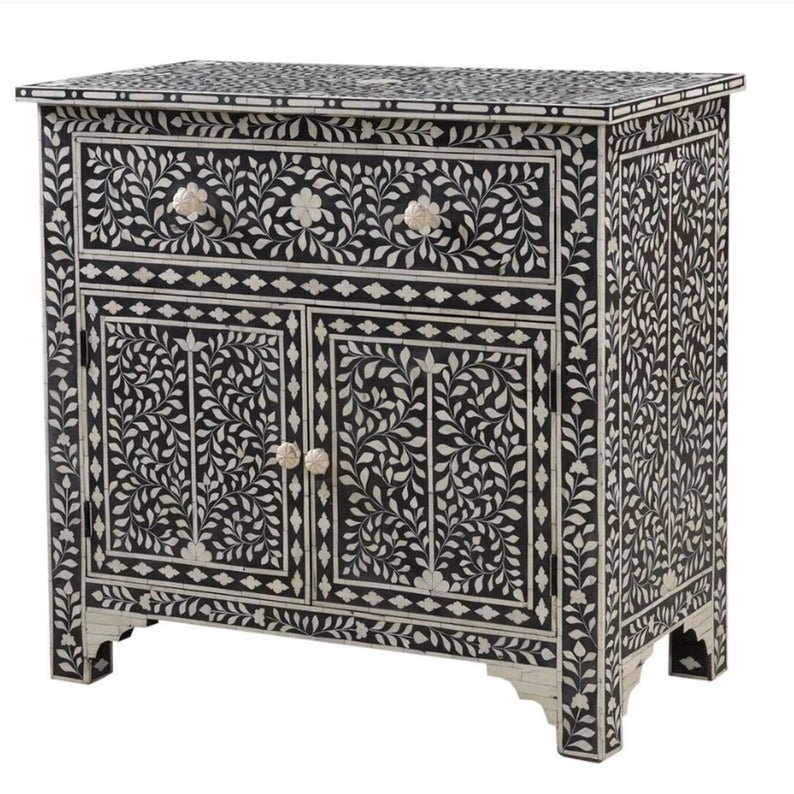 Handmade bone inlay black cupboard with ivory floral vine motifs, notched base, 1 top drawer and 2 lower doors with round bone knobs, solid wood