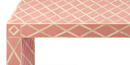 Detailed geometric diamond bone inlay pattern on a pink hallway console table, showcasing handcrafted ivory inlay work on solid wood corner edge.