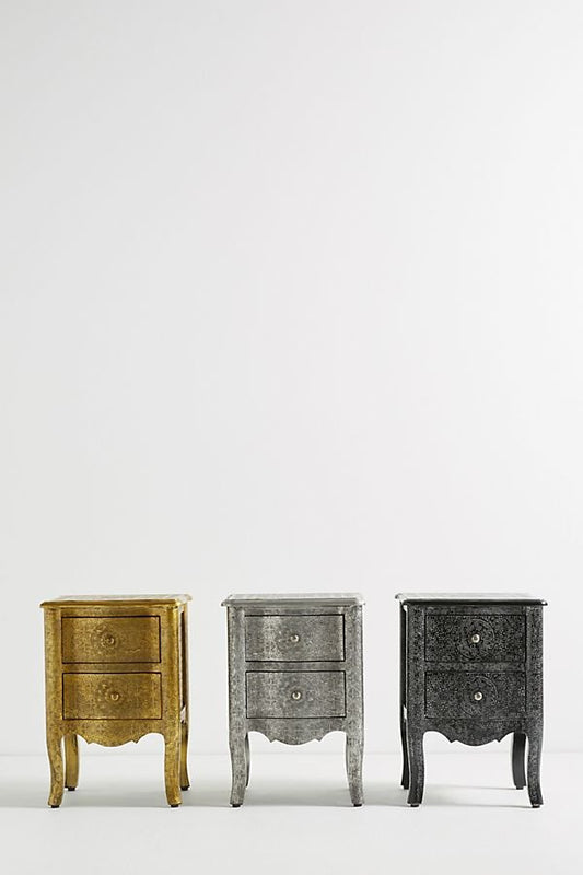 Three compact French Provincial two-drawer nightstands wrapped in hand-embossed antique gold, silver, and black metal foil on curved cabriole legs.