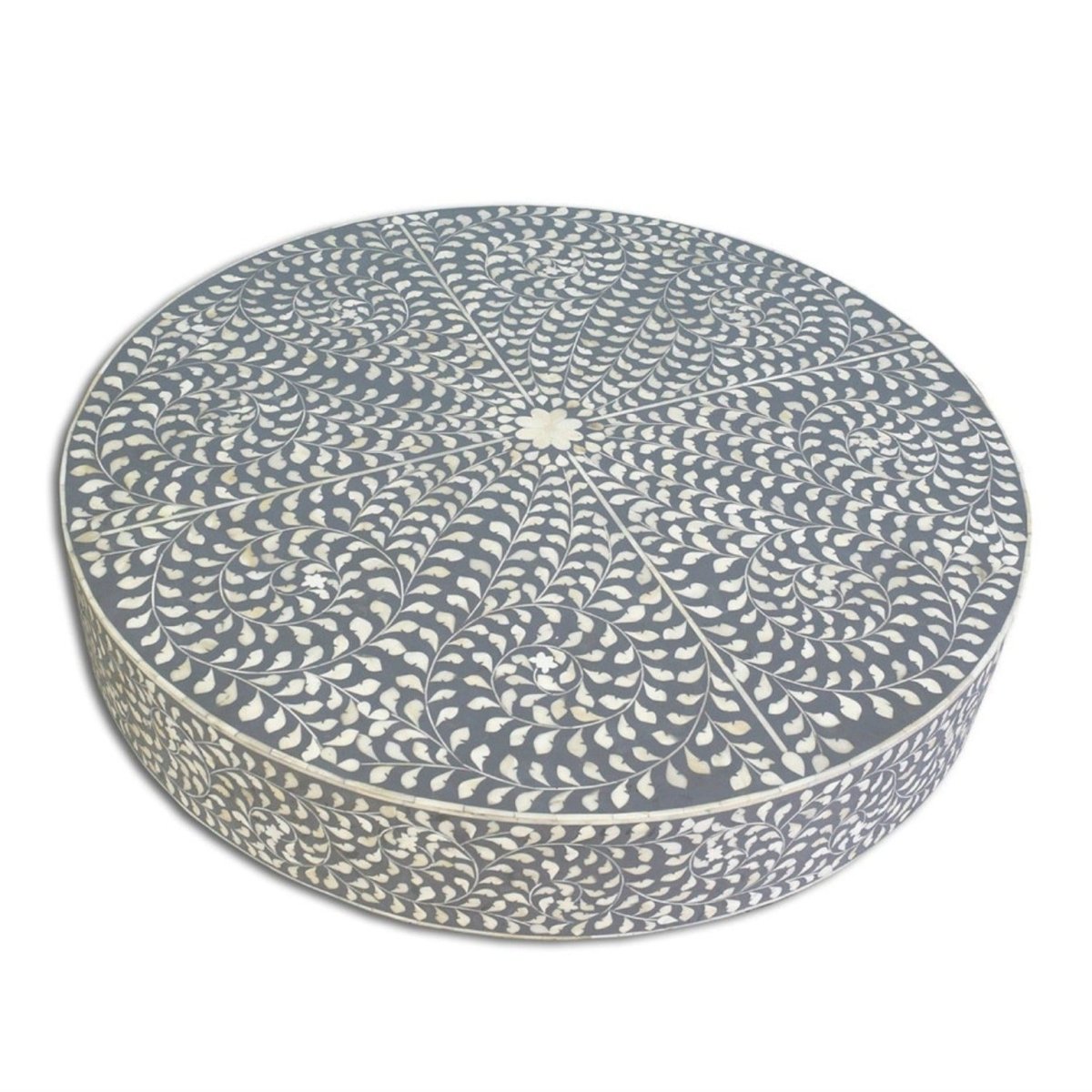 Top view of a grey round bone inlay coffee table showing the floral pattern across the tabletop.