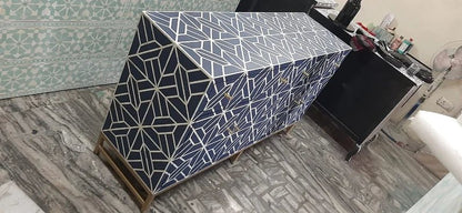 Overhead view of an indigo blue and white geometric bone inlay credenza showcasing the Iberia star pattern across the top surface and door panels