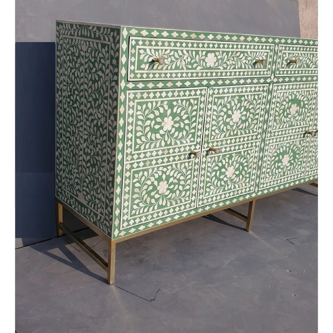 Indian bone inlay floral storage credenza in sage green with geometric diamond border and ornate white inlay work on brass stand