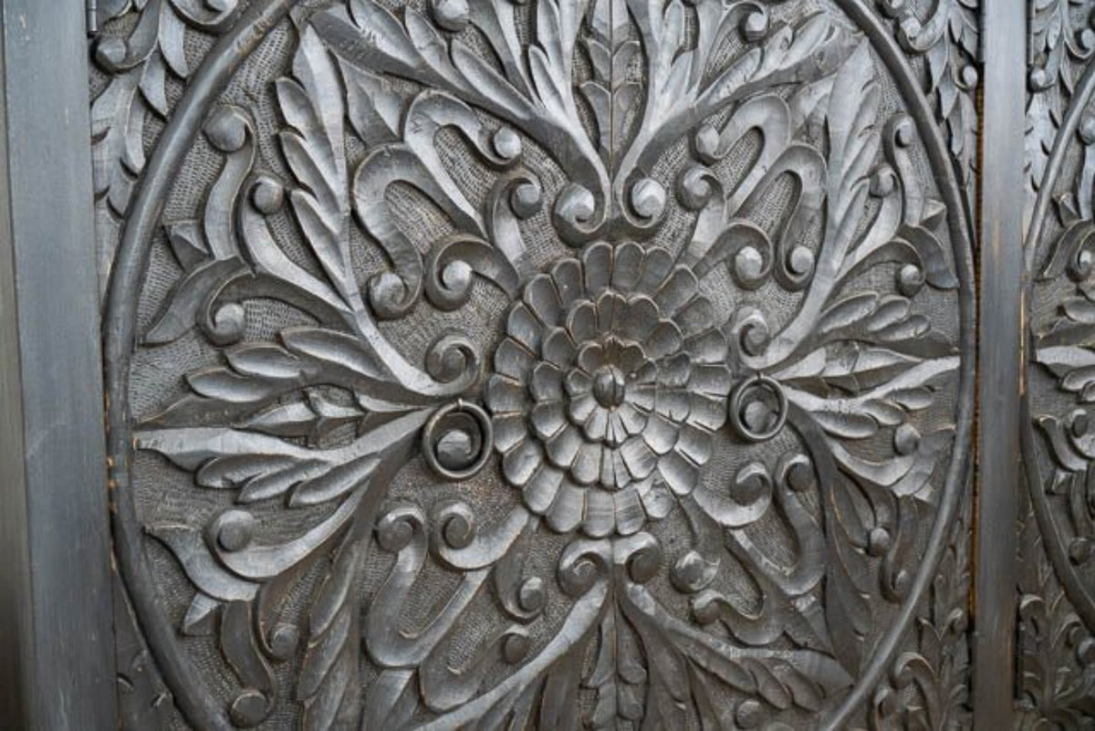Ring Pull Wood Buffet in black, shown in front view cropped closely around its carved flower and paired handles.