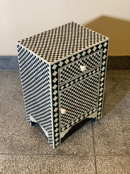 Luxury bone inlay nightstand with black and white geometric checkerboard pattern, carved floral border, single drawer and lower cabinet with white bone knobs, handmade artisan finish