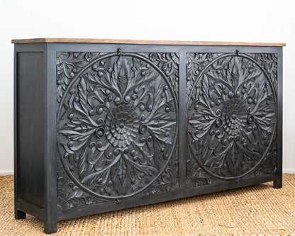 Mandala Wood Credenza in black, shown in front view at an angle revealing its natural wood top and left side.