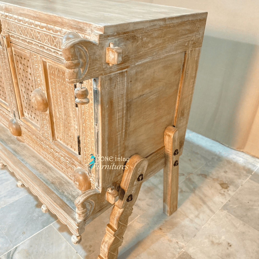 Natural paneled storage cabinet in solid wood, side profile view showing the right panel, leg braces and carved post.
Natural paneled storage cabinet in solid wood, side profile view showing the right panel, leg braces and carved post.