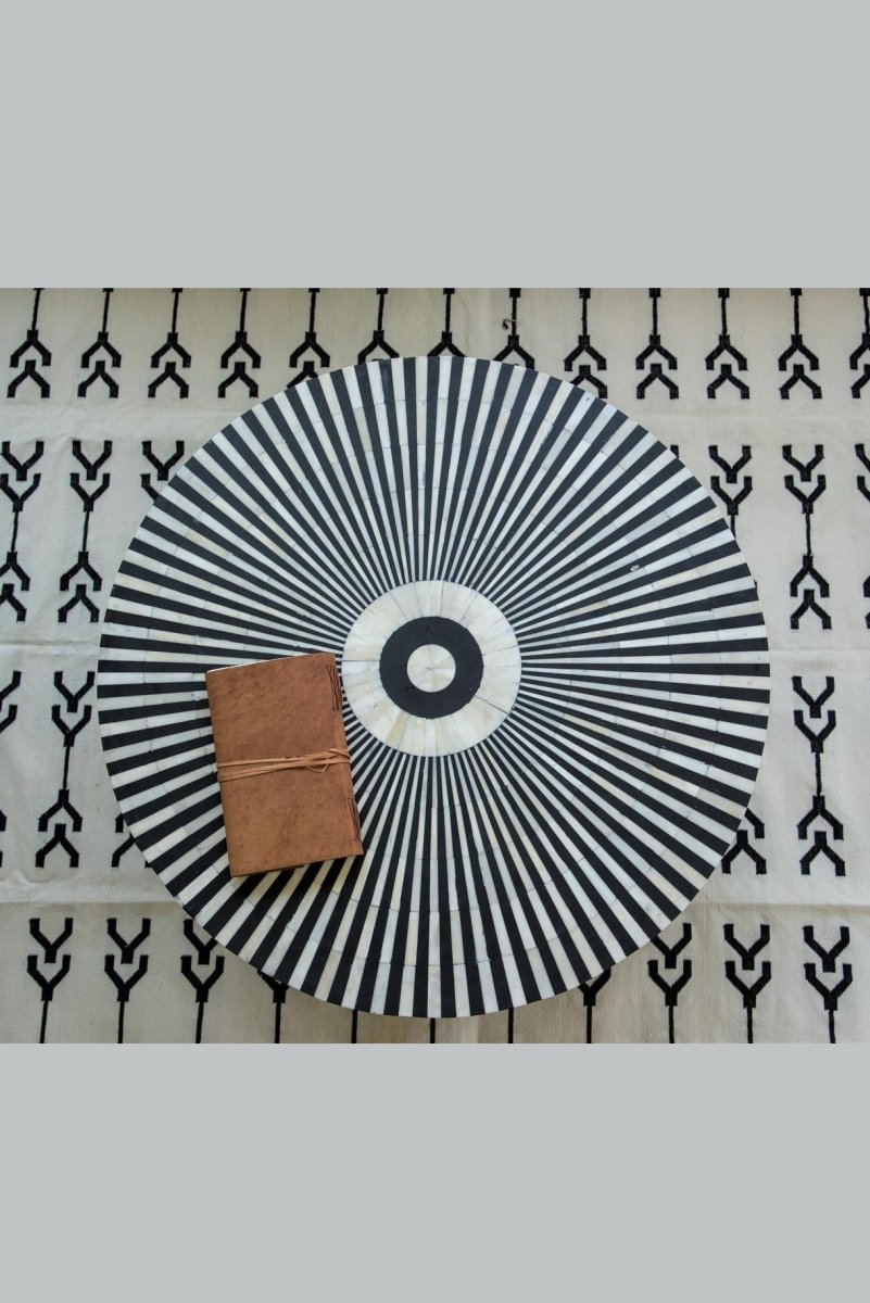 Black and white bone inlay coffee table with radial top pattern shown from directly above in a clear top view.