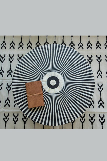 Black and white bone inlay coffee table with radial top pattern shown from directly above in a clear top view.