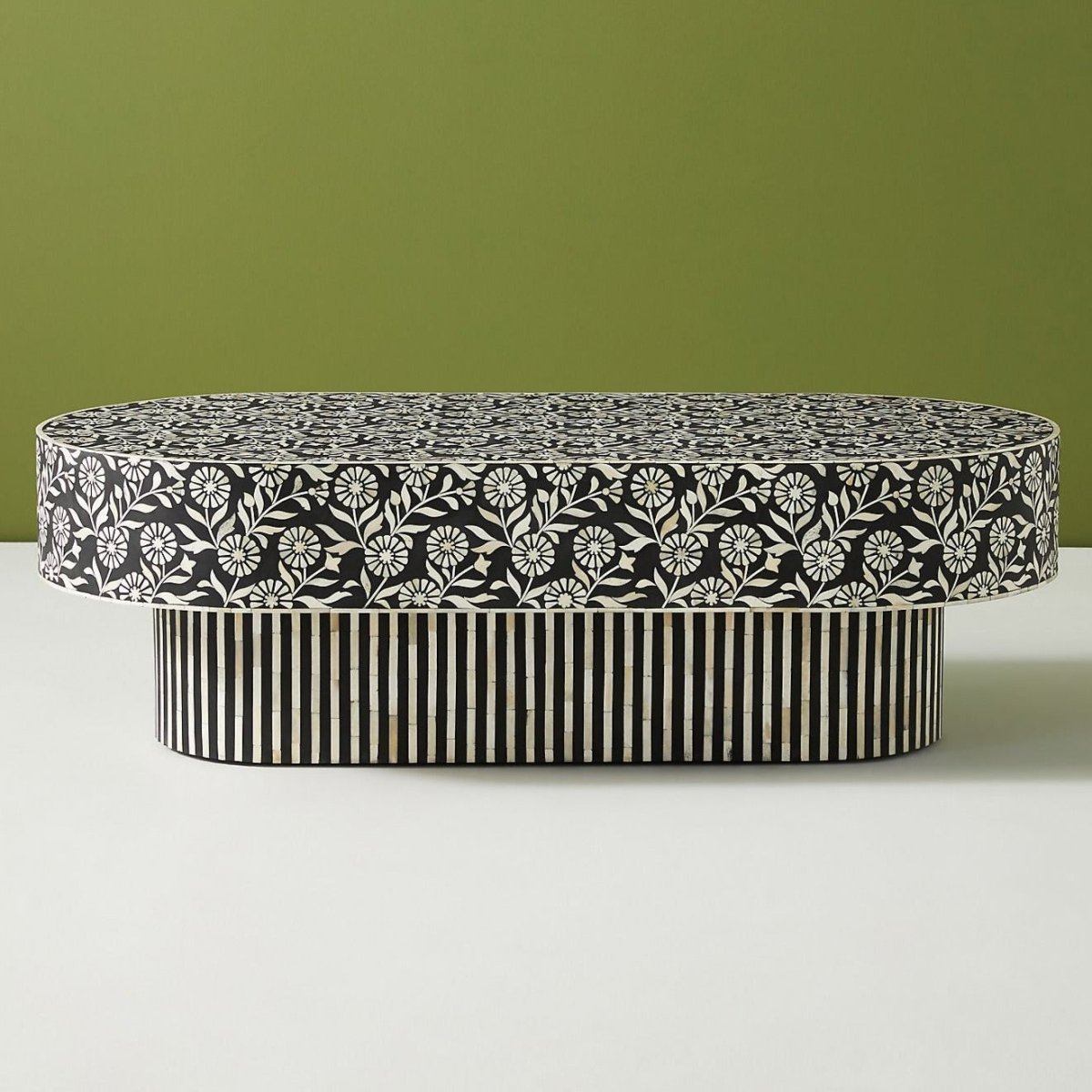 Oval Striped Inlay Center Table in black and white, shown from a three-quarter view with the patterned top and base visible.