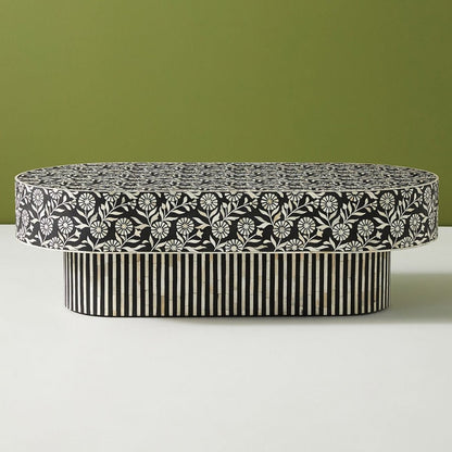 Oval Striped Inlay Center Table in black and white, shown from a three-quarter view with the patterned top and base visible.