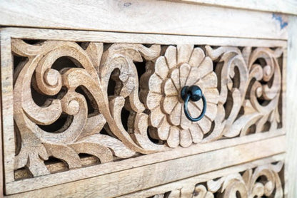 Rustic Ring Pull Dresser in pale natural wood, close-up of drawer handle surrounded by a carved flower and scrolling leaves.