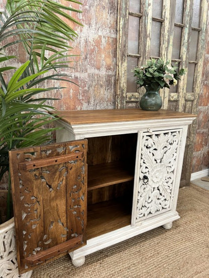 Rustic wood storage cabinet, front view with the left carved door open, revealing a natural wood interior and shelf.