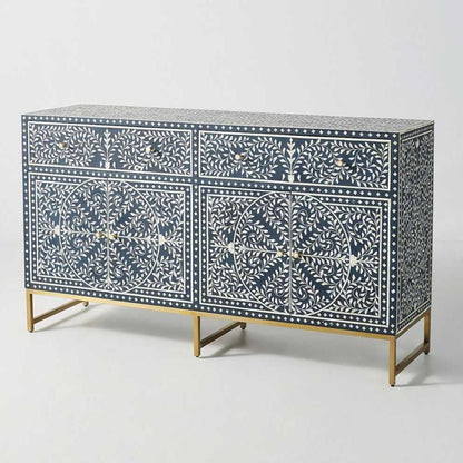 Front view of a navy blue and white scroll vine bone inlay 2-drawer, 2-door buffet with gold metal legs against a white studio background.