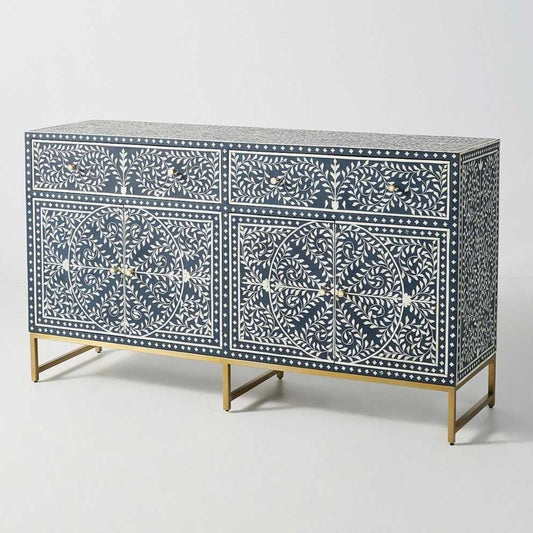 Front view of a navy blue and white scroll vine bone inlay 2-drawer, 2-door buffet with gold metal legs against a white studio background.