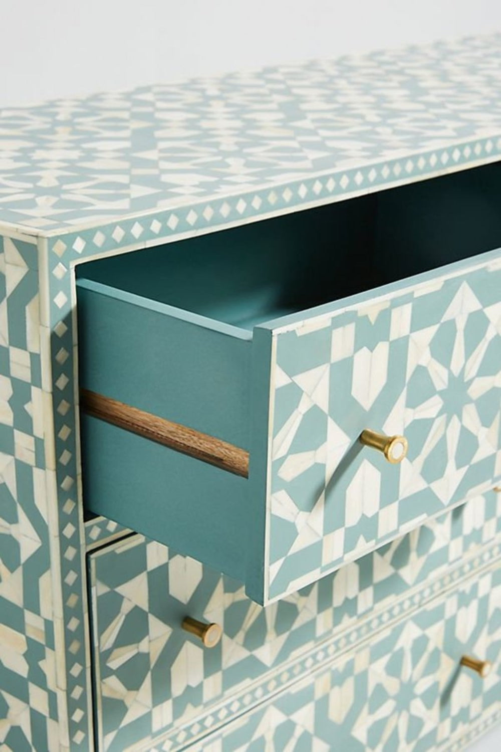 Presented as a handmade bone inlay cabinet, the Moroccan dresser shows its geometric design and close-up.